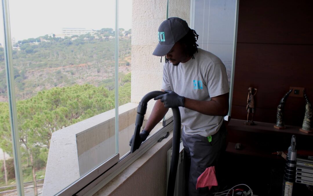 A Nine Zero cleaner deep cleaning a window rail with a professional tool.